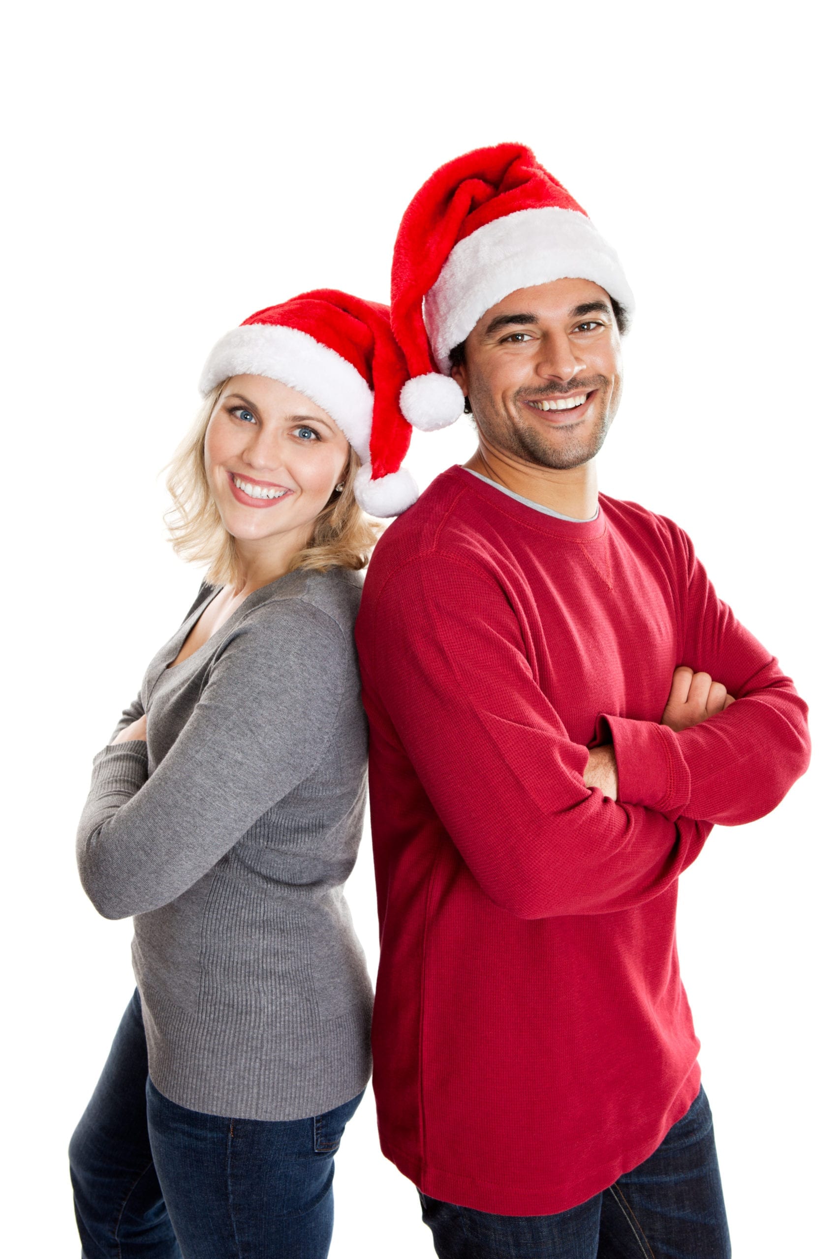a man and woman in santa hats leaning on each other