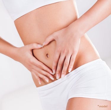 woman holding her belly showing belly button,