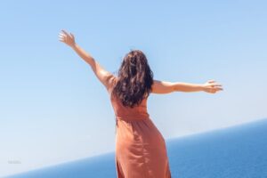 Young girl enjoying vacation, sea and warm breeze, summer vacation