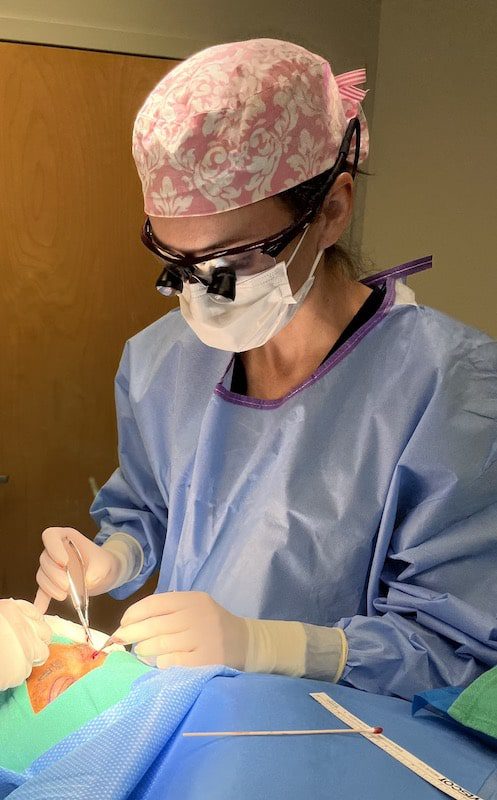 Dr. Pinell performing eyelid surgery in OR.