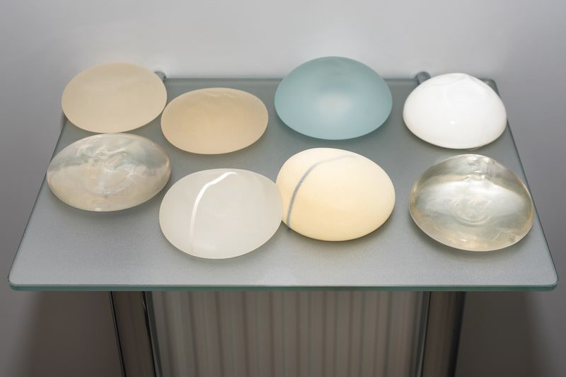 A variety of breast implants o n a table.