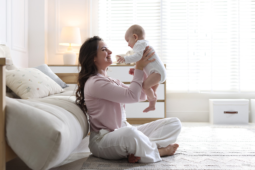 Woman playing with a baby on the floor
