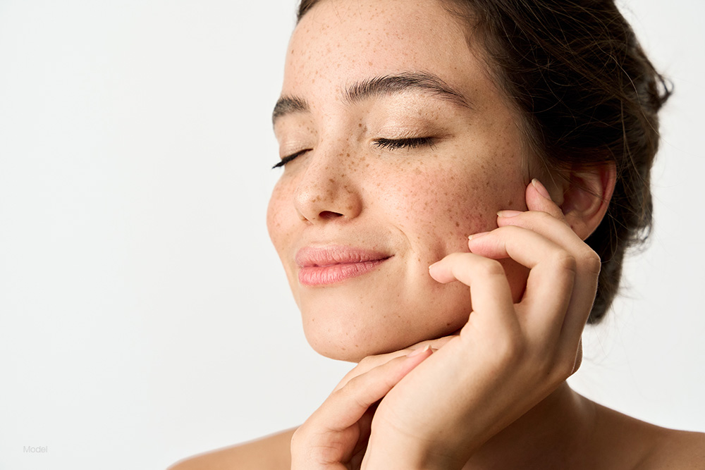 Profile of a young woman with her hand on her chin
